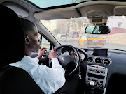 Abdourahmane, a user of the French ride-hailing app Heetch, is seen in his taxi in Dakar, Senegal.