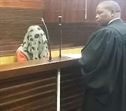 Simon Zuba covers his face after being sentenced for the assault, rape and death of his girlfriend.