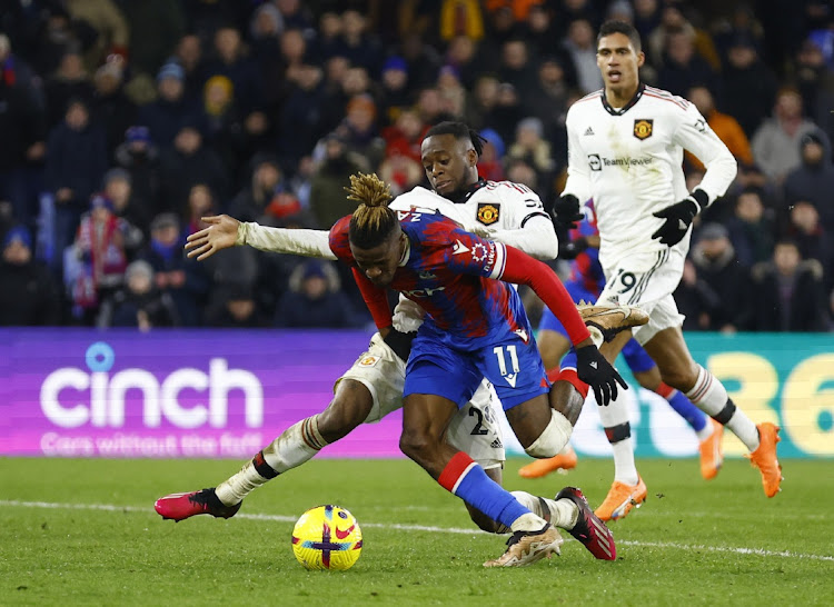 Crystal Palace's Wilfried Zaha is challenged by Manchester United's Aaron Wan-Bissaka in the Premier League matchat Selhurst Park in London on January 18 2023.