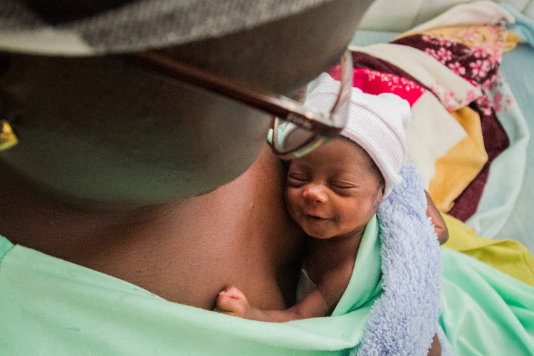 Evelyn Oduor gestures with her newborn at Kangaroo Mother Care Centre in Bungoma County Referral Hospital.