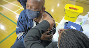 A Sasol medical worker administers the vaccine to an employee.