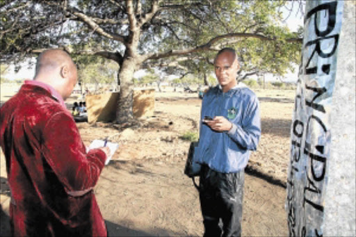 DETERMINED: School principal Evans Seanego, right, talks to Sowetan reporter Frank Maponya about the Silvermine community's intention to sue the department of education. PHOTO: ELIJAR MUSHIANA