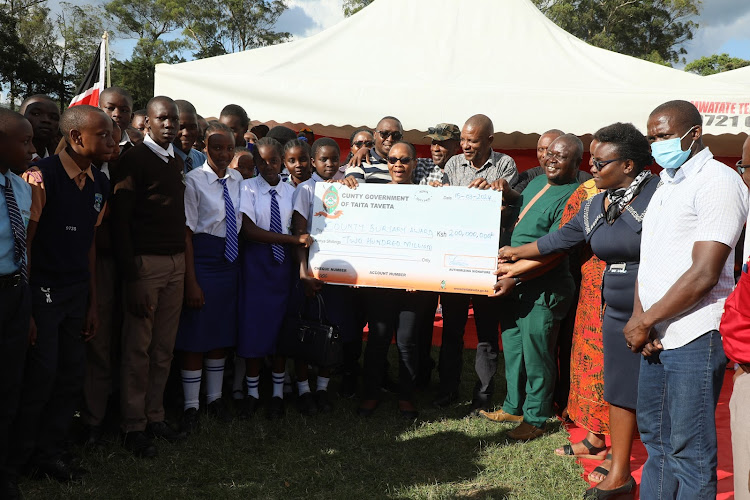 Taita Taveta Governor Andrew Mwadime with students and county leaders during the launch of Sh200 million bursary scheme at Wundanyi