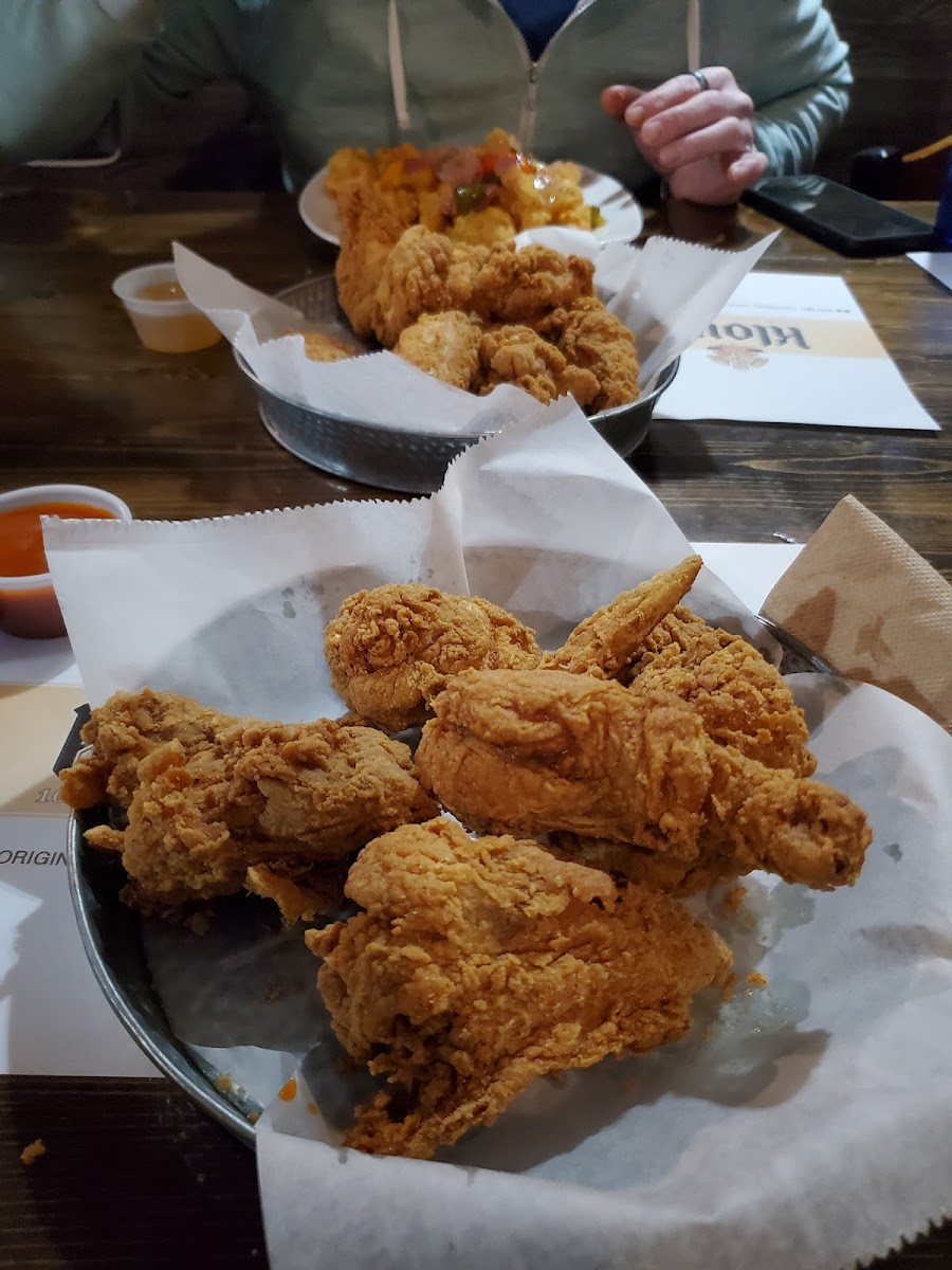 Original half order of fried chicken in front, 10 piece wings behind