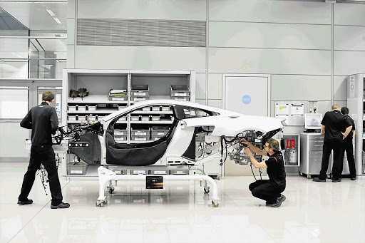 FUTURE TECH: Left, the wind tunnel. Right, crew working on the MP4-12C at the Production Centre