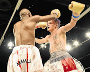 WINNING GIVES YOU WINGS: Hekkie Budler, right, about to embrace Nkosinathi Joyi after their IBO minimum-weight title match last June. Budler beat Joyi and defends his WBA and IBO strawweight titles against Pigmy Kokietgym on Saturday