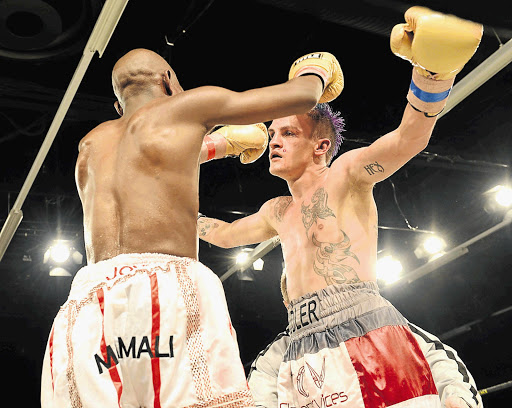 WINNING GIVES YOU WINGS: Hekkie Budler, right, about to embrace Nkosinathi Joyi after their IBO minimum-weight title match last June. Budler beat Joyi and defends his WBA and IBO strawweight titles against Pigmy Kokietgym on Saturday