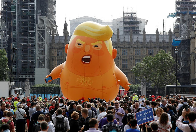 FILE PHOTO: Demonstrators fly a blimp portraying U.S. President Donald Trump, in Parliament Square, during the visit by Trump and First Lady Melania Trump, July 13, 2018. REUTERS/Peter Nicholls