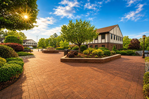 Paved walkway before building surrounded by trees - Apartment / penthouse purchase in Cedar Grove