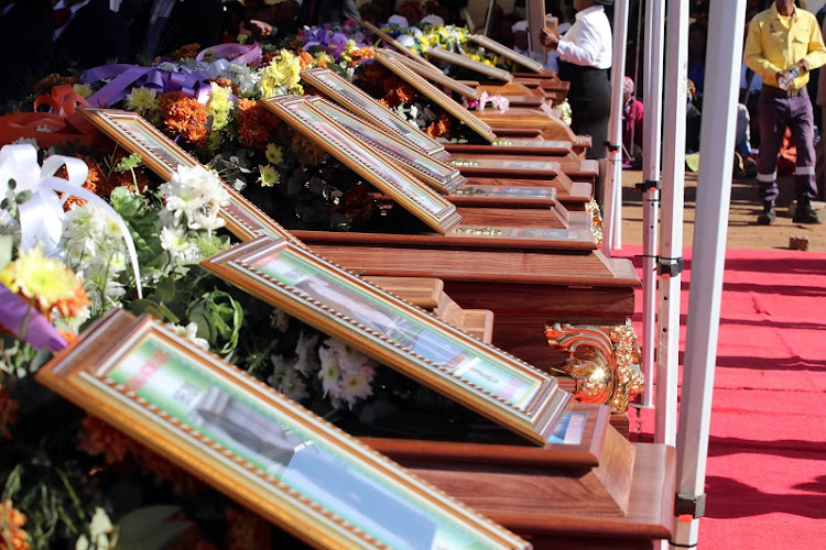 Pictures of the crash victims laid out in front of their caskets at their funeral in Senwabarwana.