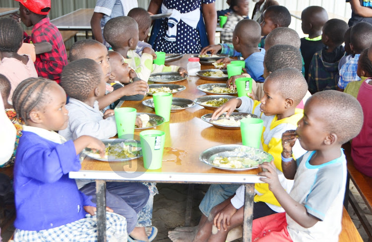 Children eat supper at the Rhonda hot kitchen