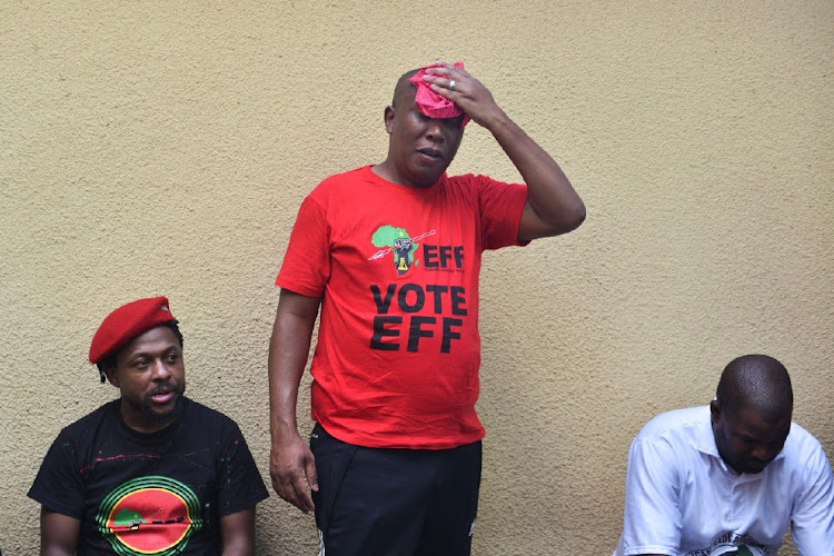 EFF leader Julius Malema wipes the sweat from his brow after a march by his supporters to the presidential compound to demand the resignation of President Cyril Ramaphosa as part of their national shutdown action.