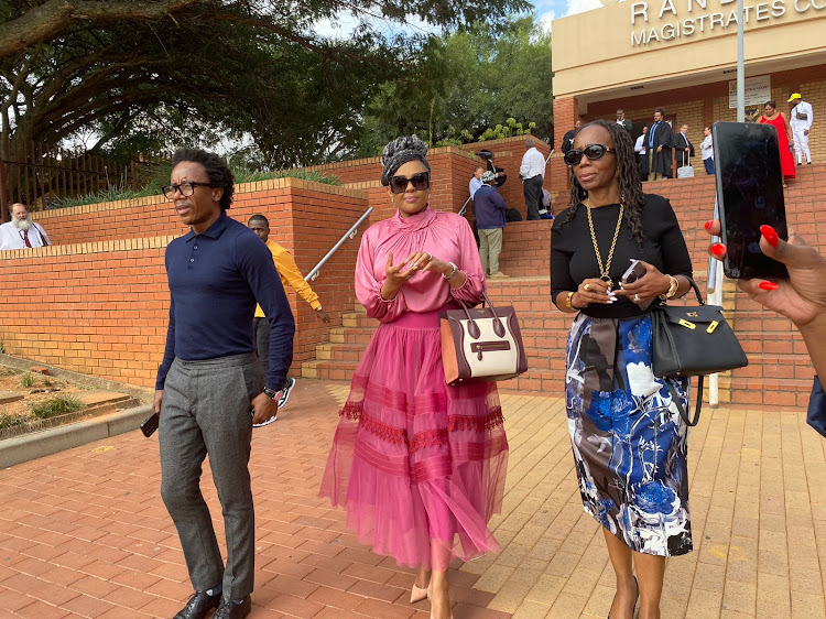 Businesswoman and beauty pageant title holder Basetsana Kumalo leaves the Randburg magistrate's court with friends.