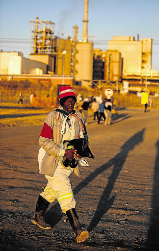 BACK TO WORK: A platinum miner goes for a medical checkup at Lonmin's Rowland shaft before he can go down the mine