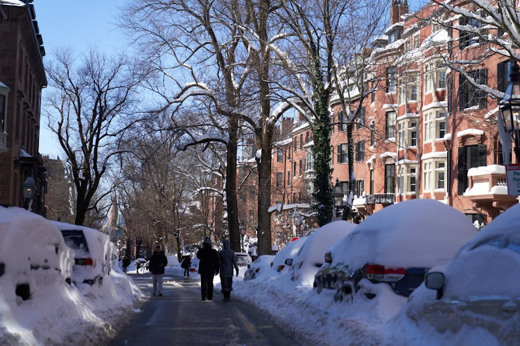 Boston tied a daily snow record, and blizzard conditions were confirmed across New England and Long Island from a storm that also dumped more than 8 inches in Central Park and even more to the east.