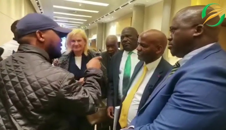 A screenshot of a video of journalists and SA Football Association national executive committee members in heated discussion after a press conference descended into chaos at Sandton Convention Centre in Johannesburg on June 24 2022.