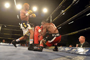 Azinga Fuzile knocks down Tshifhiwa Munyai during the Four go to War boxing bout at Emperors Palace on October 21, 2017 in Johannesburg, South Africa. 