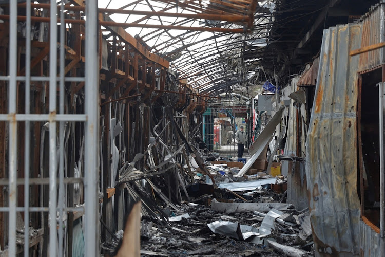 A local resident stands next to debris of an open market destroyed by a military strike, as Russia's attack on Ukraine continues, in Sievierodonetsk, Luhansk region, Ukraine April 16, 2022.