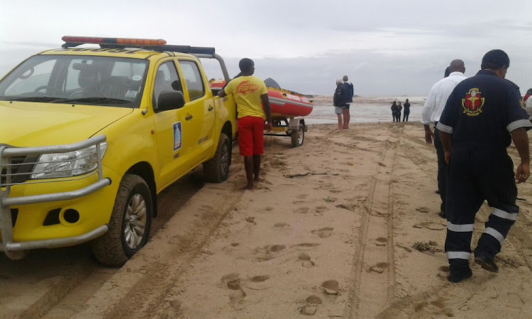 Emergency service personnel at the scene after a ski boat capsized on the South Coast.