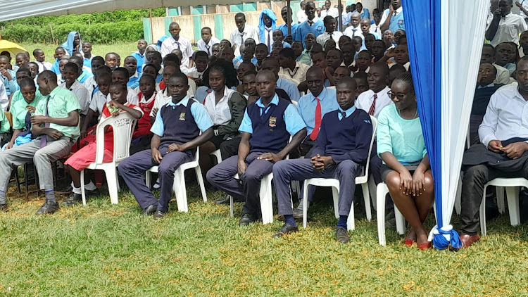 Students from various schools from Gem Constituency on Monday wait to receive cheques for bursaries awarded to them by Siaya County government at Lundha mixed secondary school in North Gem on Monday.