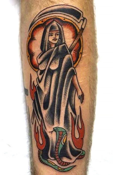 Guy shows his leg tattoo depicting the female grim reaper