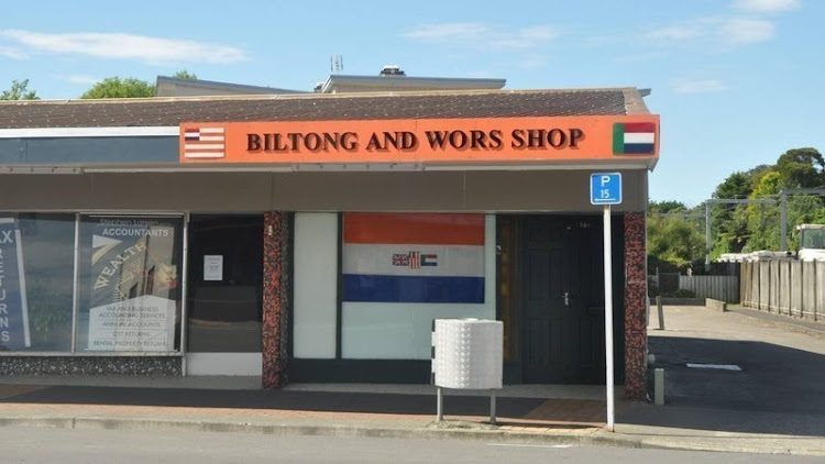 Angry residents are demanding the removal of the old SA flag from the front window of the Biltong and Wors Shop in Tawa, New Zealand.