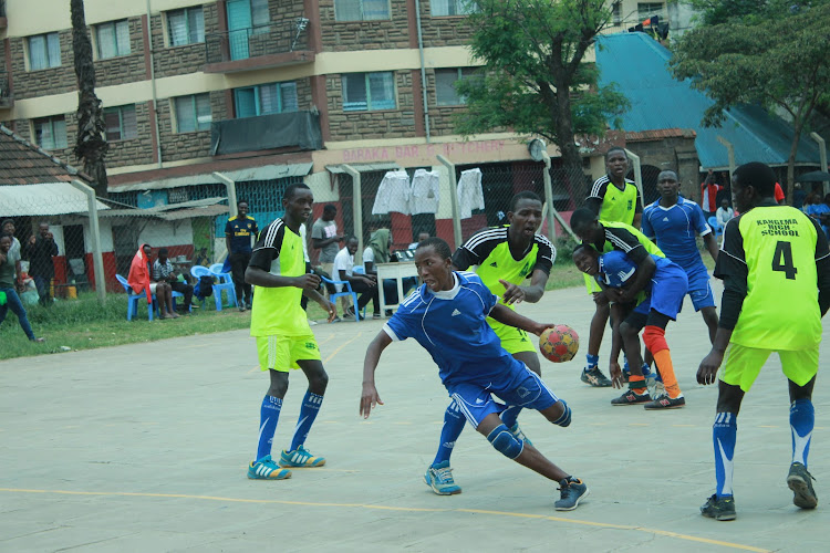 Fidel Katua positions himself to shoot at goal as Moses Kimani tries to tackle him from behind on November 10 at Kaloleni Sports Grounds.