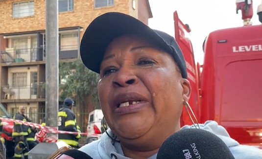 A distraught mother is searching for her daughter outside the block of flats which was gutted by fire in the Johannesburg city centre.