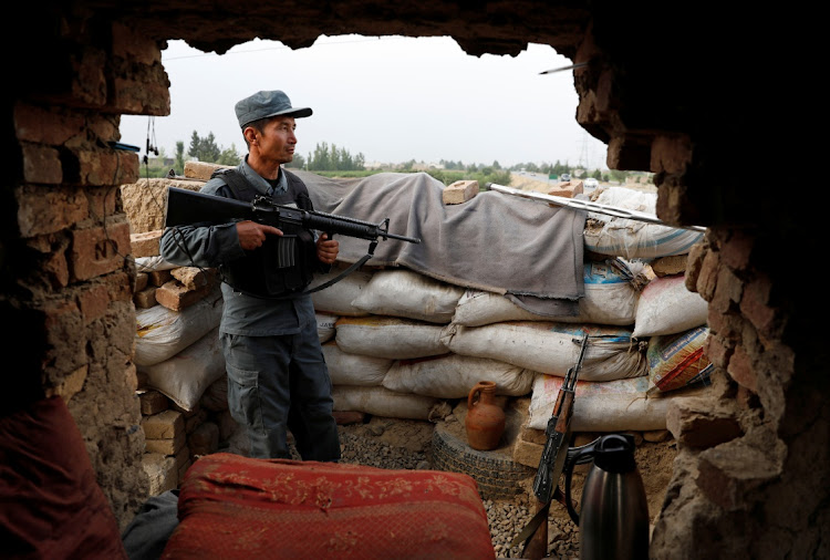 An Afghan policeman keeps watch at the check post on the outskirts of Kabul, Afghanistan July 13, 2021.