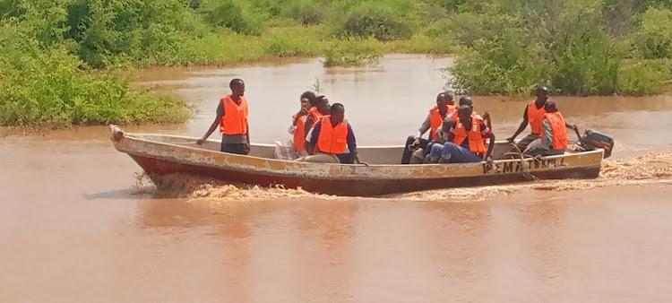 Boat operators carying passengers between Madogo and Garissa towns on Wednesday, May 1, 2024.