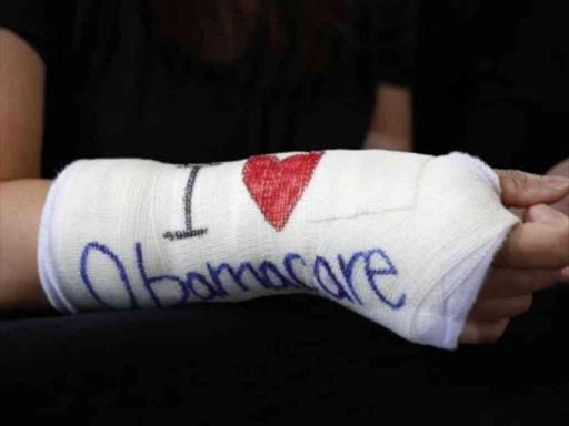 Cathey Park of Cambridge, Massachusetts wears a cast for her broken wrist with "I Love Obamacare" written upon it. /Reuters December 22, 2016