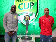 Mamelodi Sundowns goalkeeper Denis Onyango, left, poses with the trophy with Summerfield Dynamos midfielder Deolin Mekoa after the two teams were drawn against each other in the competition's quarterfinal draw in Johannesburg on March 14 2022. 