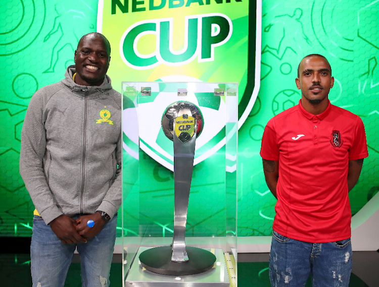 Mamelodi Sundowns goalkeeper Denis Onyango, left, poses with the trophy with Summerfield Dynamos midfielder Deolin Mekoa after the two teams were drawn against each other in the competition's quarterfinal draw in Johannesburg on March 14 2022.