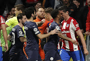 Stefan Savic of Atletico Madrid and players of Manchester City clash during their UEFA Champions League quarter final second leg match at the Estadio Wanda Metropolitano in Madrid on Wednesday night.
