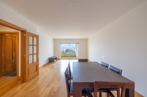 Dining room with dark wood table in this luxury property for rent in Cascais ($3,983)