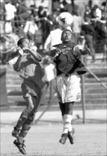 AERIAL CLASH: Bophelo Impilo Private School's Nhlanhla Nkhambule fights for the ball with RW Fick High School's Phillip Malombo at the recent Kay Motsepe Cup. The Tourney kicks off on March 6. Pic. Veli Nhlapo. 05/05/2004. © Sowetan.