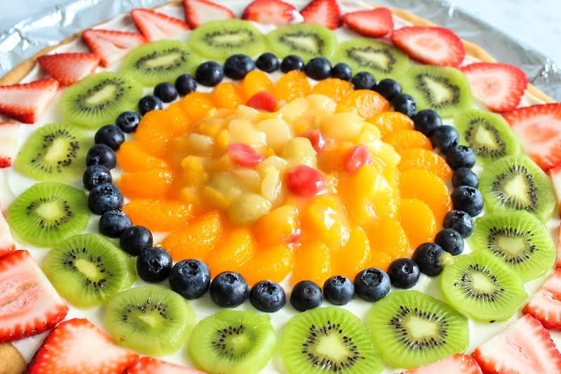 Arranging Fruit On The Pizza.