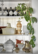 A shelf acts as both storage and display for the eclectic crockery collection and other objets.