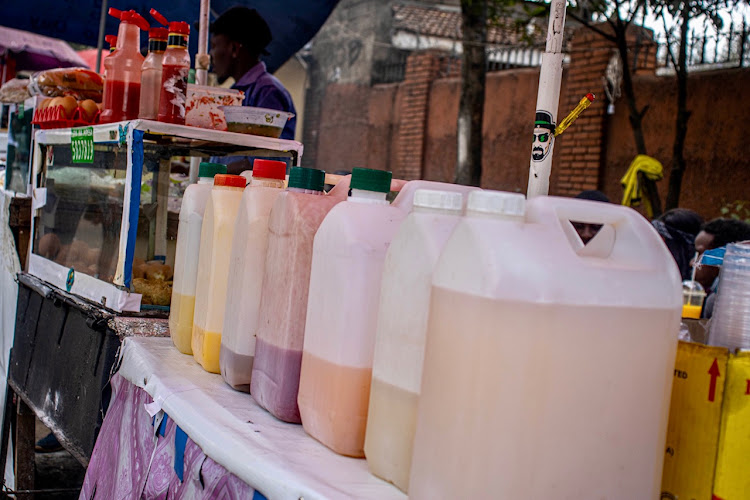 Bottles of different types of juices displayed in a wooden table