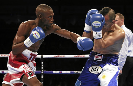 Zolani Tete (left) against Omar Andres Narvaez in their WBO title bout. /Brian Lawless / Getty Images