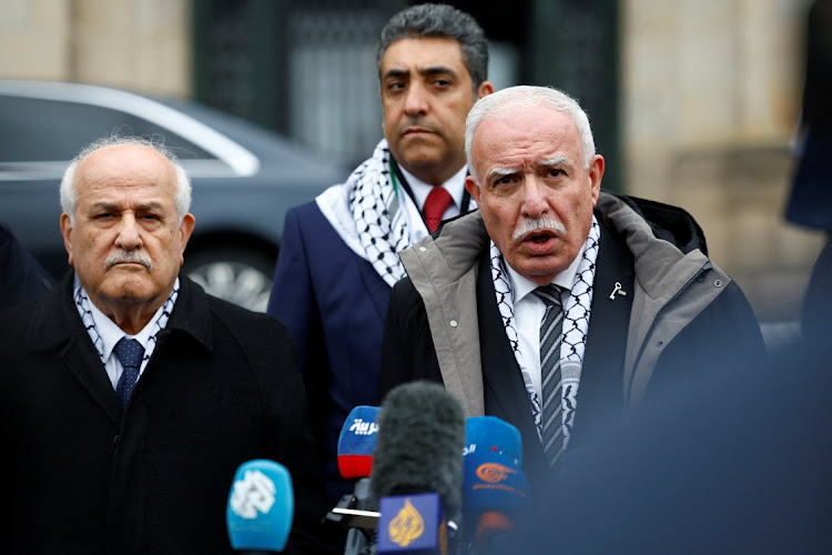 Palestinian foreign minister Riyad al-Maliki gives a statement to the media, next to Palestinian UN envoy Riyad Mansour and Omar Awadallah, senior official in the Palestinian foreign ministry, on the day of a public hearing held by the International Court of Justice (ICJ) to allow parties to give their views on the legal consequences of Israel’s occupation of the Palestinian territories before eventually issuing a non-binding legal opinion in The Hague, Netherlands, on Monday. Picture: REUTERS/PIROSCHKA VAN DE WOUW