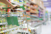 A trolley being pushed down a supermarket aisle.