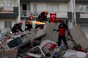Rescue operations take place on a site after an earthquake struck the Aegean Sea, in the coastal province of Izmir, Turkey, on October 31 2020. 
