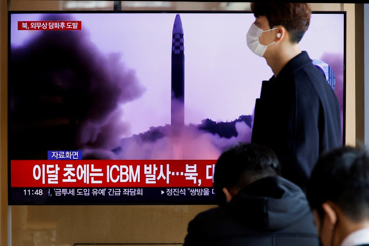 A man walks past a TV broadcasting a news report, on North Korea firing a ballistic missile off its east coast, in Seoul, South Korea, November 17, 2022.