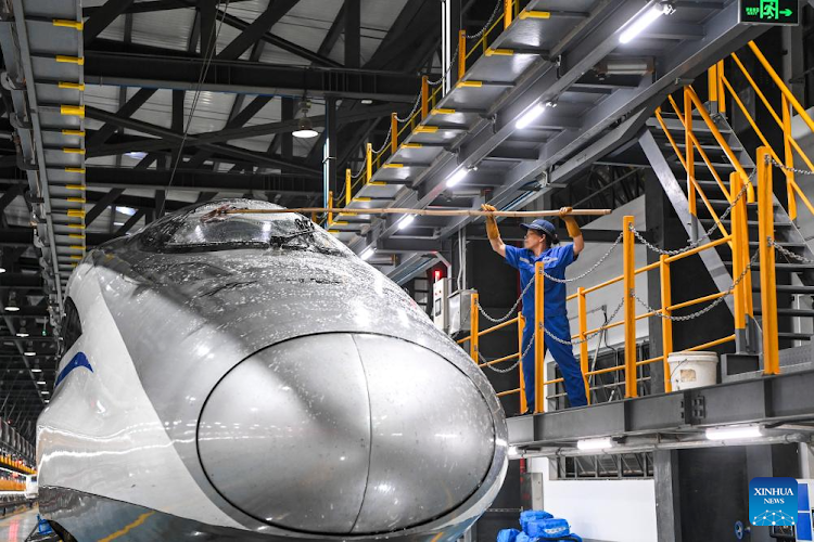 A staff member cleans the body of a bullet train at a train maintenance workshop in Nanning City, south China's Guangxi Zhuang Autonomous Region, May 1, 2024. In recent years, there has been a growing emphasis on innovation and entrepreneurship, with Labour Day celebrations featuring events promoting creativity and innovation in the workplace.