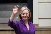 New Conservative Party leader and incoming prime minister Liz Truss waves as she leaves party headquarters on September 5 2022 in London.