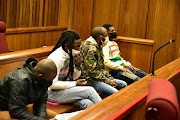 From left Fikile Mengo, Mkhuseli Ngqanda, Thanduxolo Vumazonke, and Sinethemba Nenembe in the dock of the high court in Gqeberha on Wednesday for the brutal murder of murder of Denise Webber, 78.
