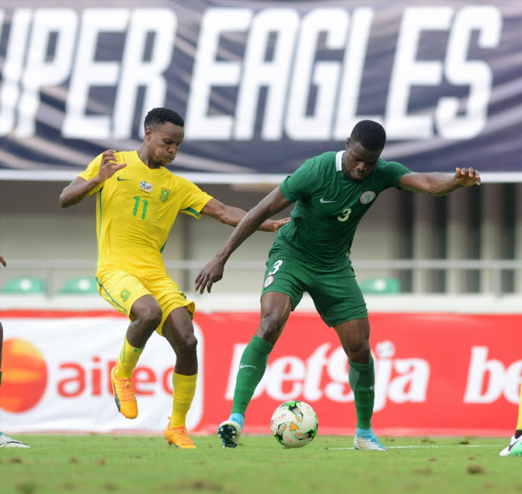 Bafana Bafana midfielder Themba Zwane (L) vies for the ball against Elderson Echiejile of Nigeria during the 2019 Africa Cup of Nations Qualifying match between Nigeria and South Africa at Godswill Akpabio International Stadium on June 10, 2017 in Uyo State, Nigeria.