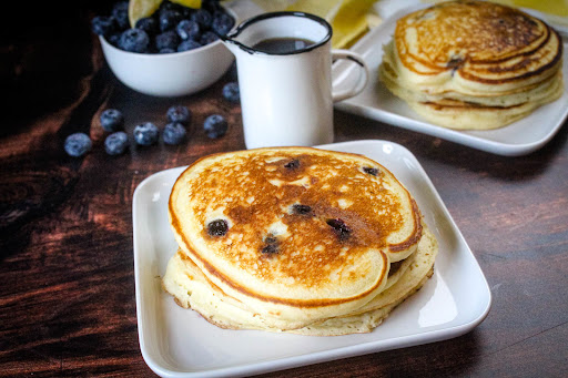 A plate of Fluffy Lemon Blueberry Pancakes.