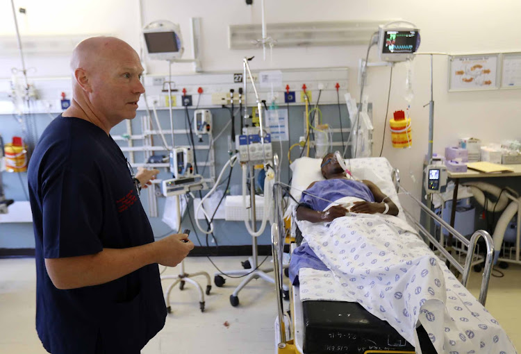 Professor Andrew Nicol, head of trauma at Groote Schuur Hospital, with a stab-wound patient.